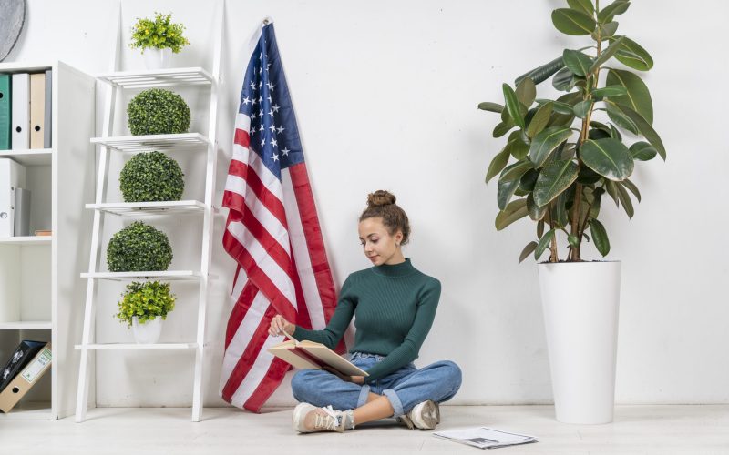 full-shot-girl-sitting-floor-reading-indoors